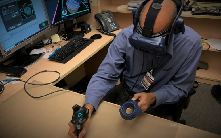 A radiologist or doctor using VR to create a 3D printing medical model